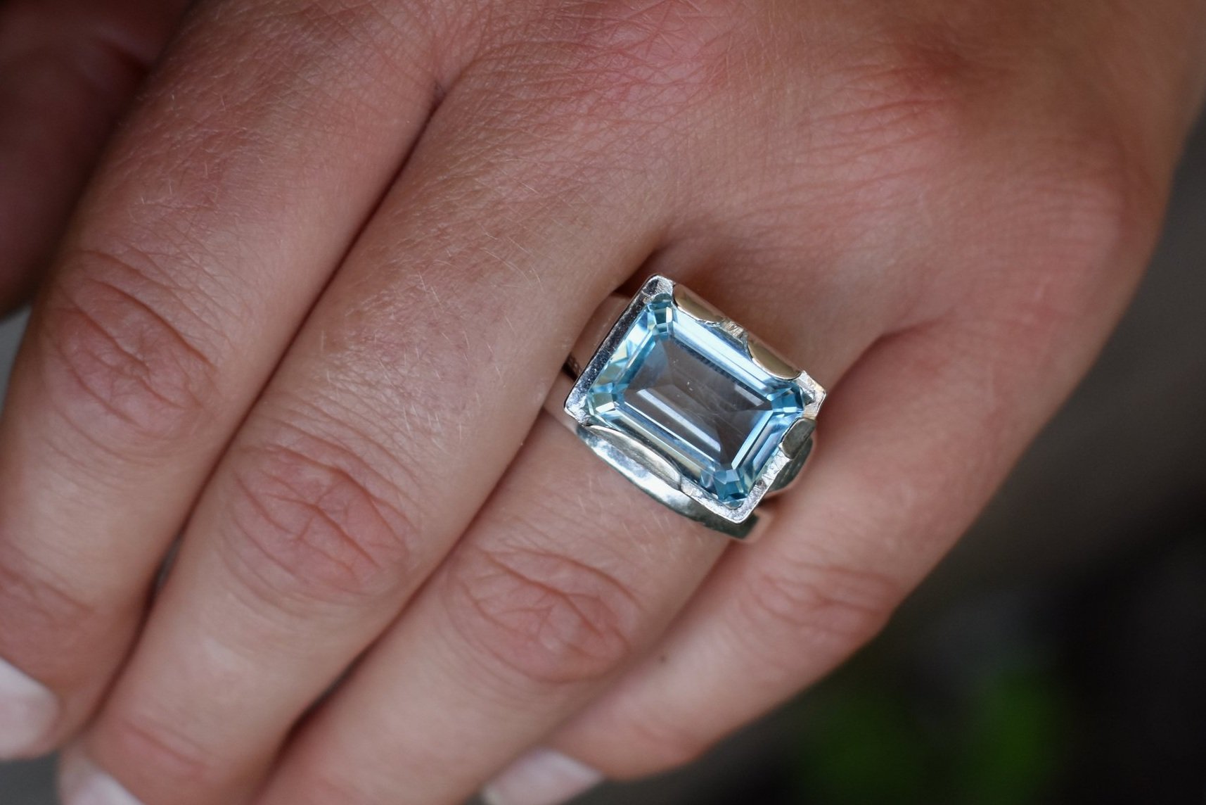 This is a beautiful emerald cut blue topaz set into a hand made solid silver setting. This stone is ethically sourced and the silver is 100% recycled
blue topaz statement ring cocktail party style large engagement ring in silver emerald cut stone ring diamond ring tiffany engagement sparkle silver stack ring