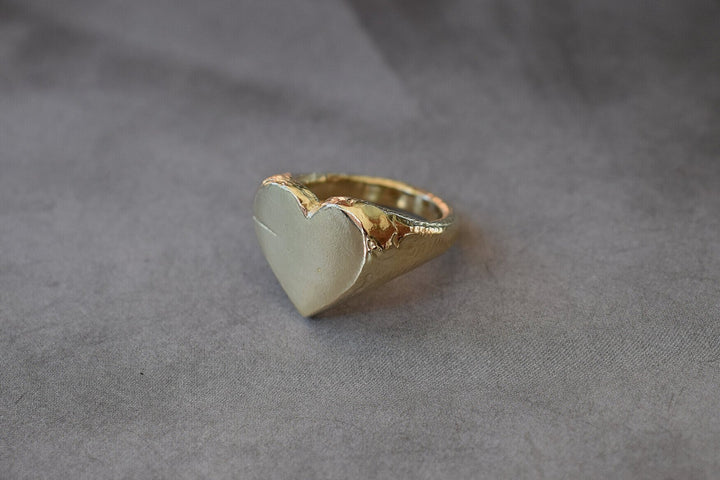 Classic love heart ring in gold. Luxury big chunky heart-shaped signet ring. Made from 100% recycled gold This heart ring is a perfect gift to the person that you love. Signature heart ring a timeless classic that goes with any style ladies statement heart signet ring tiffany heart ring signet ring heart shaped love ring