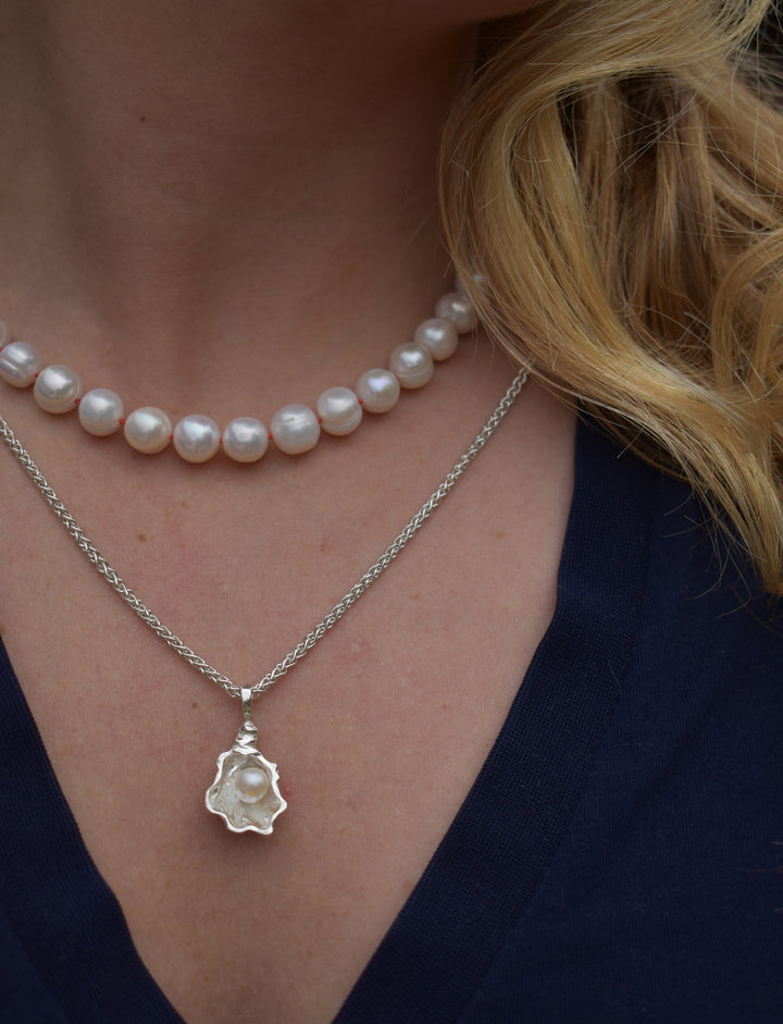 Large freshwater pearl hand strung necklace. Round, imperfect hand knotted with natural silk and set with a solid silver clasp. Pearl necklace choker style Ivory breakfast at tiffanys necklace