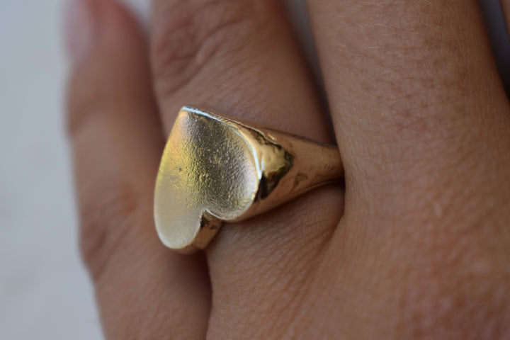 Classic love heart ring in gold. Luxury big chunky heart-shaped signet ring. Made from 100% recycled gold This heart ring is a perfect gift to the person that you love. Signature heart ring a timeless classic that goes with any style ladies statement heart signet ring tiffany heart ring signet ring heart shaped love ring