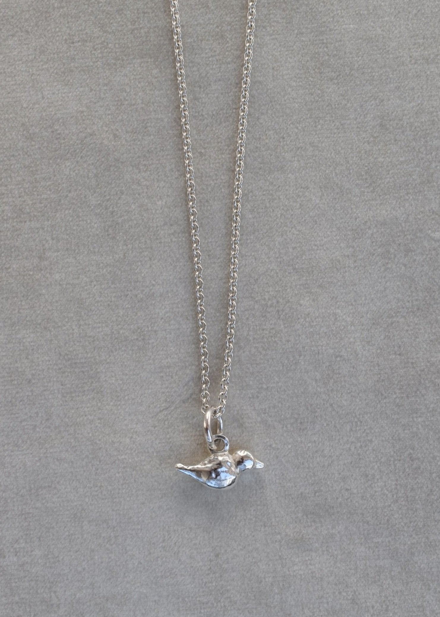 mini hand carved bird charm on silver trace chain. Silver bird charm represents love and freedom and spring time. charm necklace silver necklace layering 21st birthday gift mother's day gift mother and daughter necklace