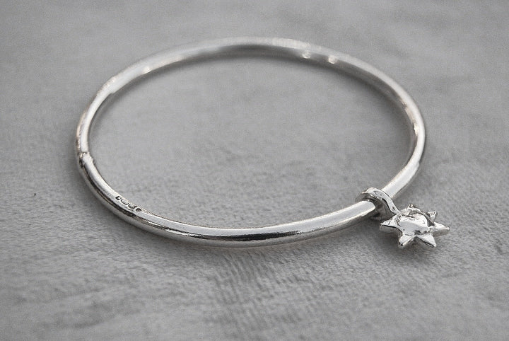 Solid silver round wire bangle with a mini sunshine charm. Can be worn alone or with a combination of other bangles from the collection. Round thick silver stack bangle silver cuff charm bracelet round solid silver bangle ladies bracelet with charm personalised word bracelet bangle stack silver