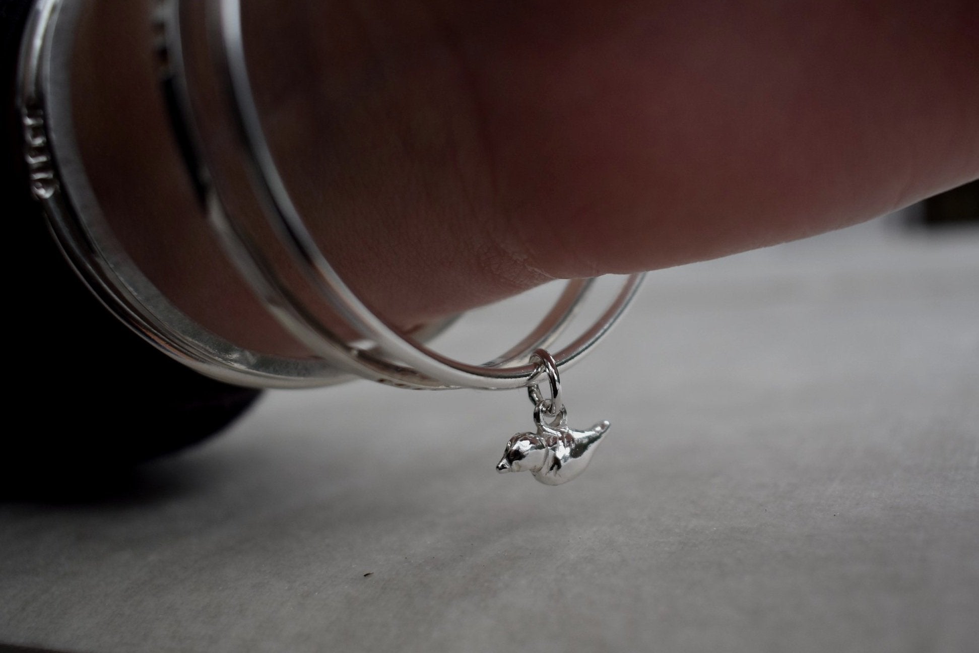 Solid silver round wire bangle with a mini bird charm. handmade to order. Solid silver round wire bangle with a mini bird charm. Can be worn alone or with a combination of other bangles from the collection. Round thick silver stack bangle silver cuff charm bracelet round solid silver bangle ladies bracelet with charm personalised word bracelet bangle stack silver. bird jewellery silver bird charm.
