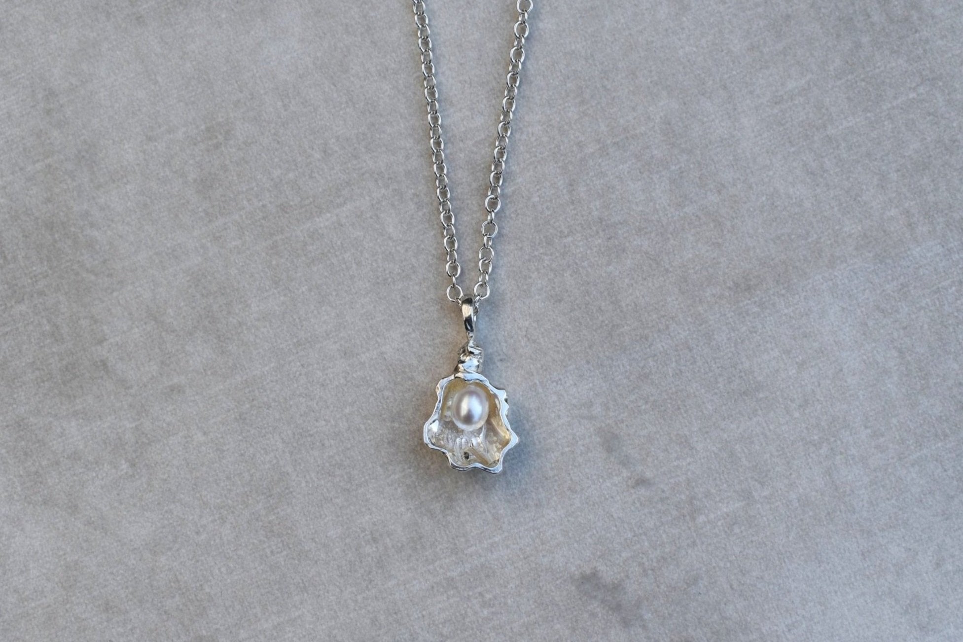 silver oyster necklace with freshwater pearl
oyster charm seaside jewellery beach style pendant gift for love world is your oyster