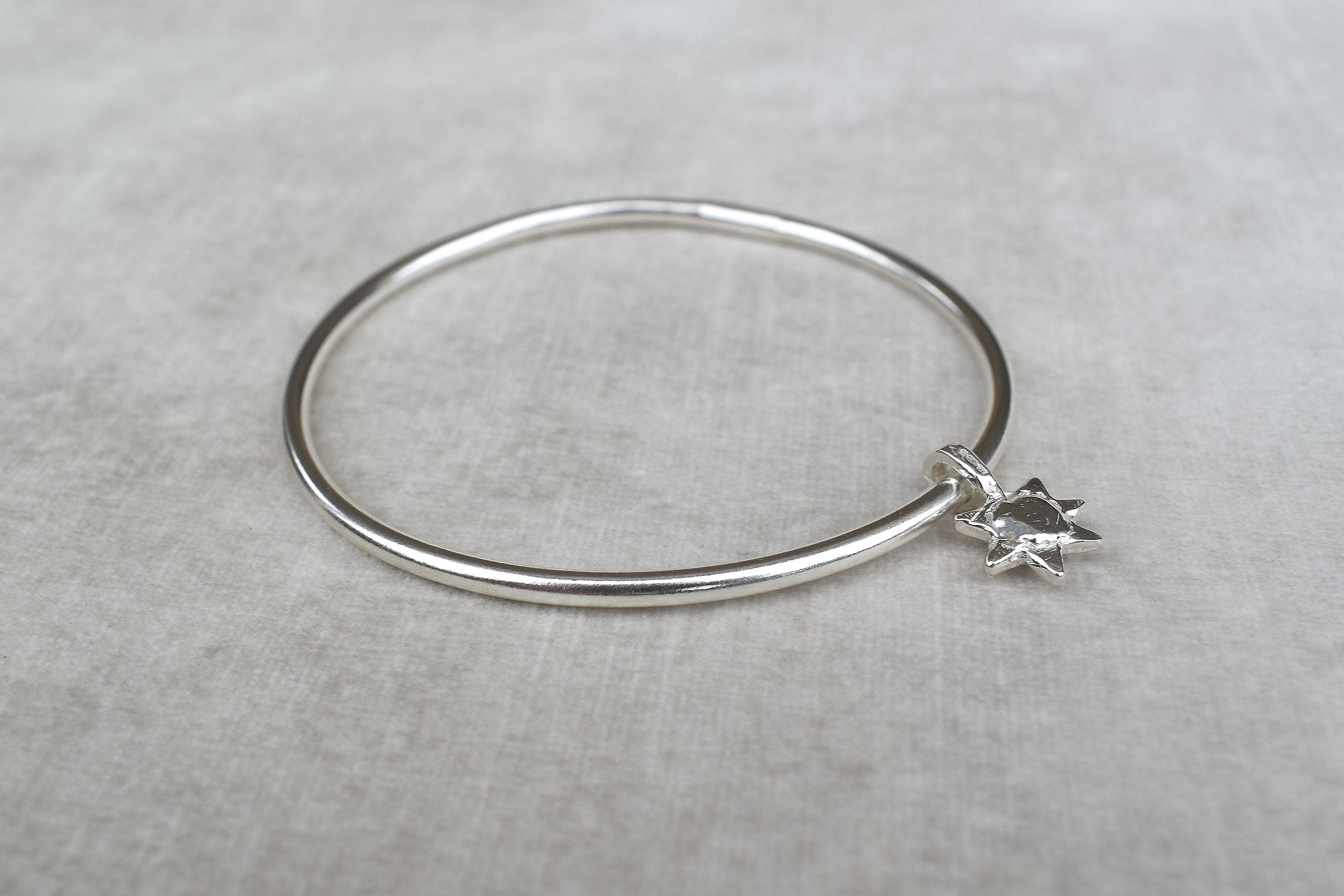 Solid silver round wire bangle with a mini sunshine charm. Can be worn alone or with a combination of other bangles from the collection. Round thick silver stack bangle silver cuff charm bracelet round solid silver bangle ladies bracelet with charm personalised word bracelet bangle stack silver