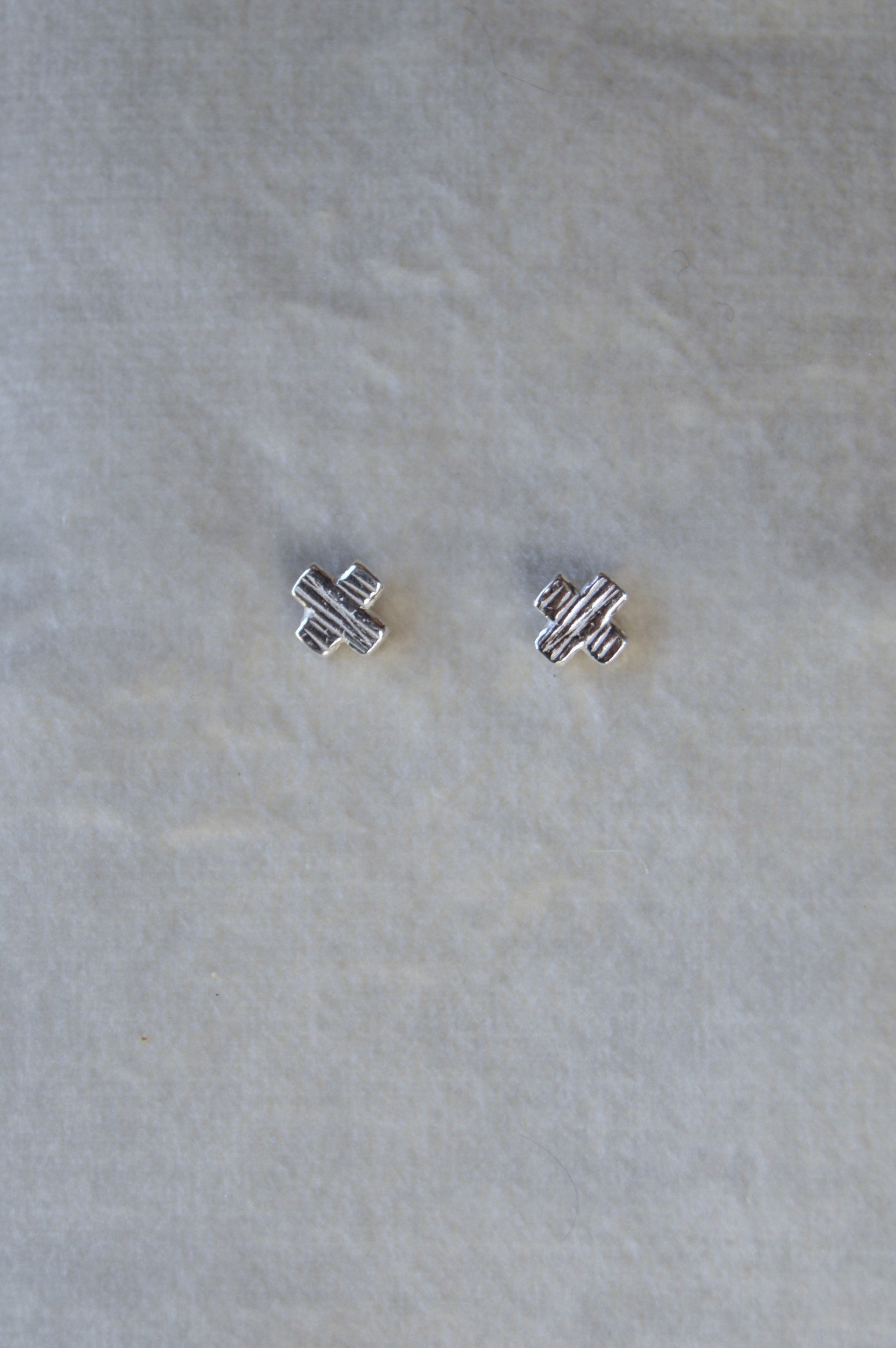 Silver X shape studs. From the noughts & crosses collection mini stud one size.
Mini XO shape stud charm silver earrings XO gift for her gift for him silver charm earrings
