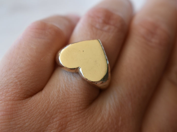 Classic love heart ring in gold. Luxury big chunky heart-shaped signet ring. Made from 100% recycled gold This heart ring is a perfect gift to the person that you love. Signature heart ring a timeless classic that goes with any style ladies statement heart signet ring