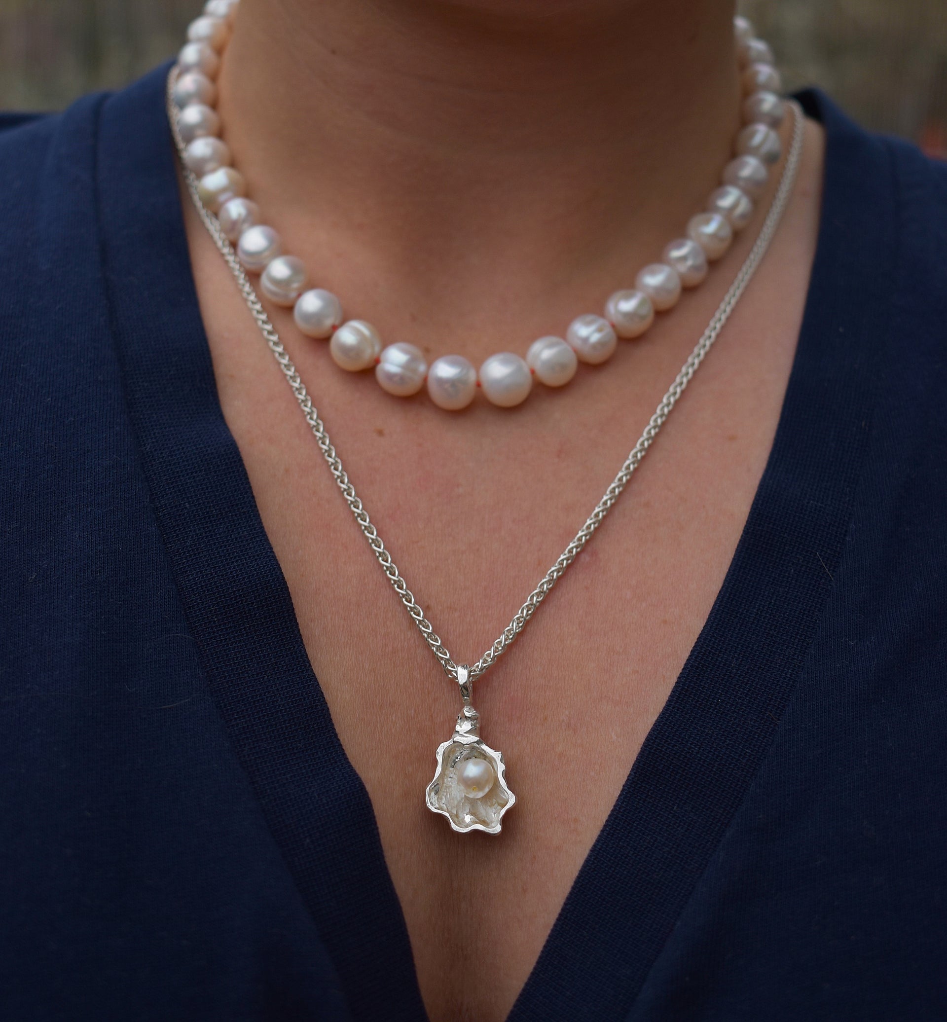 Large freshwater pearl hand strung necklace. Round, imperfect hand knotted with natural silk and set with a solid silver clasp. Pearl necklace choker style Ivory breakfast at tiffanys necklace