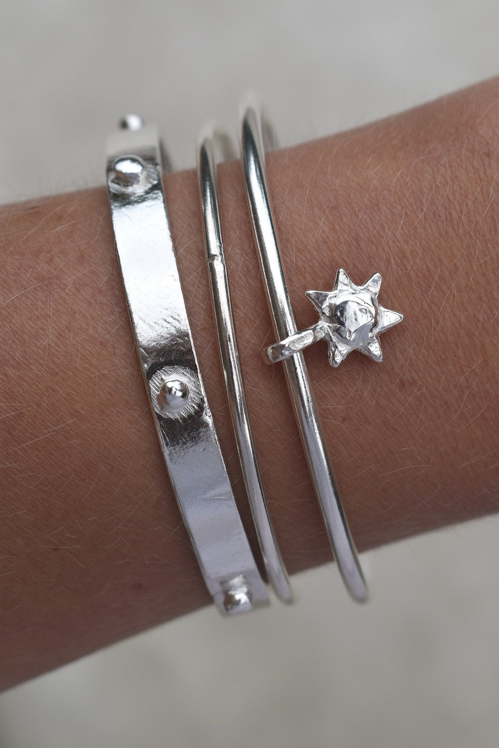 Thick solid silver hand sculpted bangle with medieval style studs. thick heavy silver cuff bangle round stack bangle personalised hand made bangle bracelet. Can be worn alone or with a combination of other bangles from the collection, thick or thin. 
