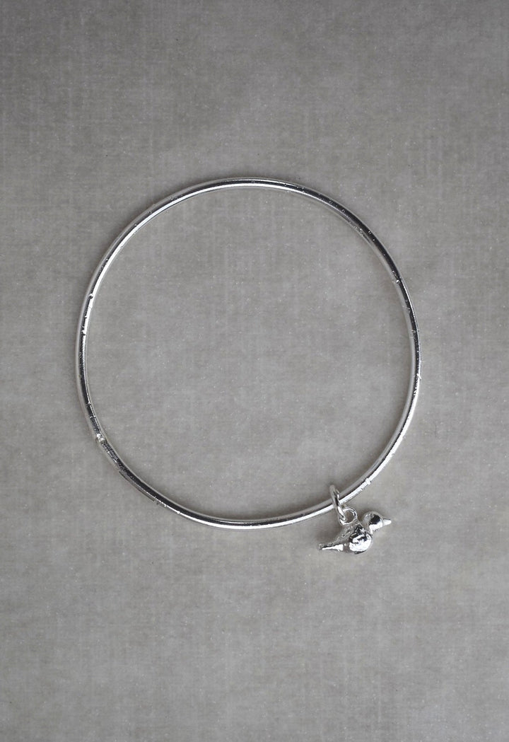 Solid silver round wire bangle with a mini bird charm. handmade to order. Solid silver round wire bangle with a mini bird charm. Can be worn alone or with a combination of other bangles from the collection. Round thick silver stack bangle silver cuff charm bracelet round solid silver bangle ladies bracelet with charm personalised word bracelet bangle stack silver. bird jewellery silver bird charm.