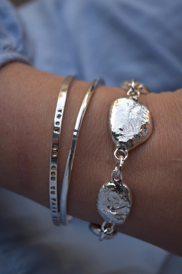 Unique silver pebble links make up this heavy bracelet. Made to order from recycled silver each pebble is totally unique. Hallmarked for silver.
Chunky silver nugget heavy silver charm bracelet. Heavy link chain bracelet