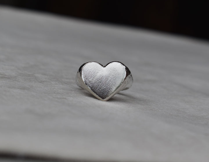 Classic love heart ring in silver. Luxury big chunky heart-shaped signet ring. Made from 100% recycled silver, hallmarked and stamped with individual maker’s mark. This heart ring is a perfect gift to the person that you love. Signature heart ring a timeless classic that goes with any style ladies statement heart signet ring